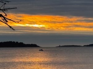 Peaceful sunset over the sea with soft evening light, symbolizing calm, reflection, emotional stillness, and returning to yourself through nature.